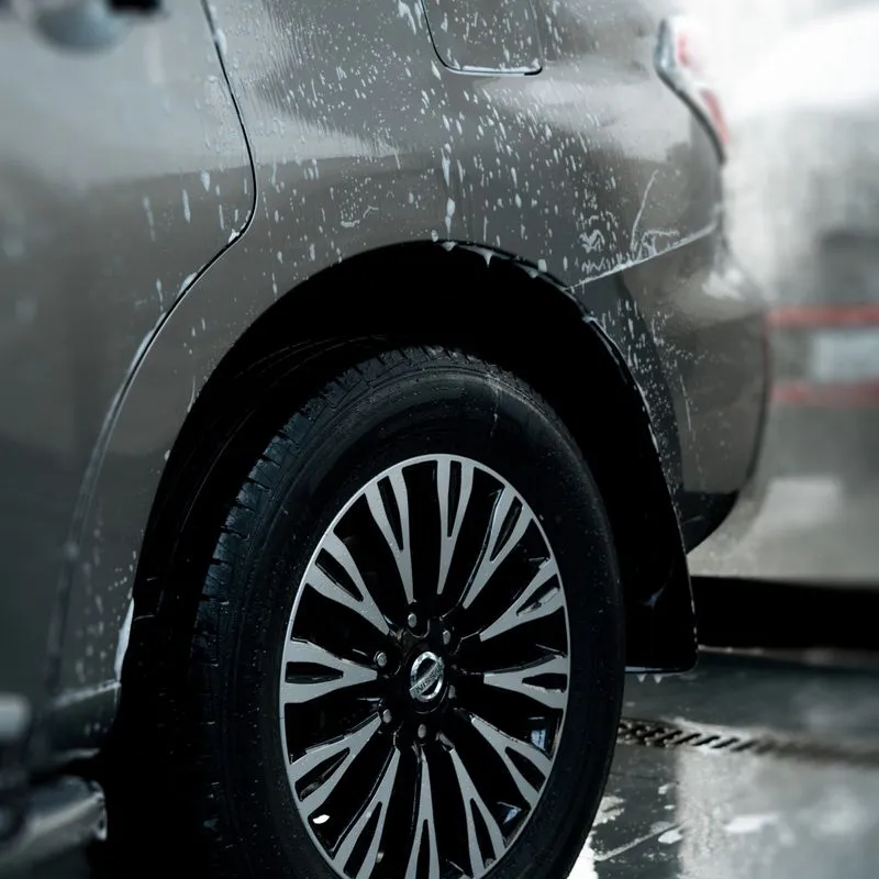 Close-up of a car wheel during a wash